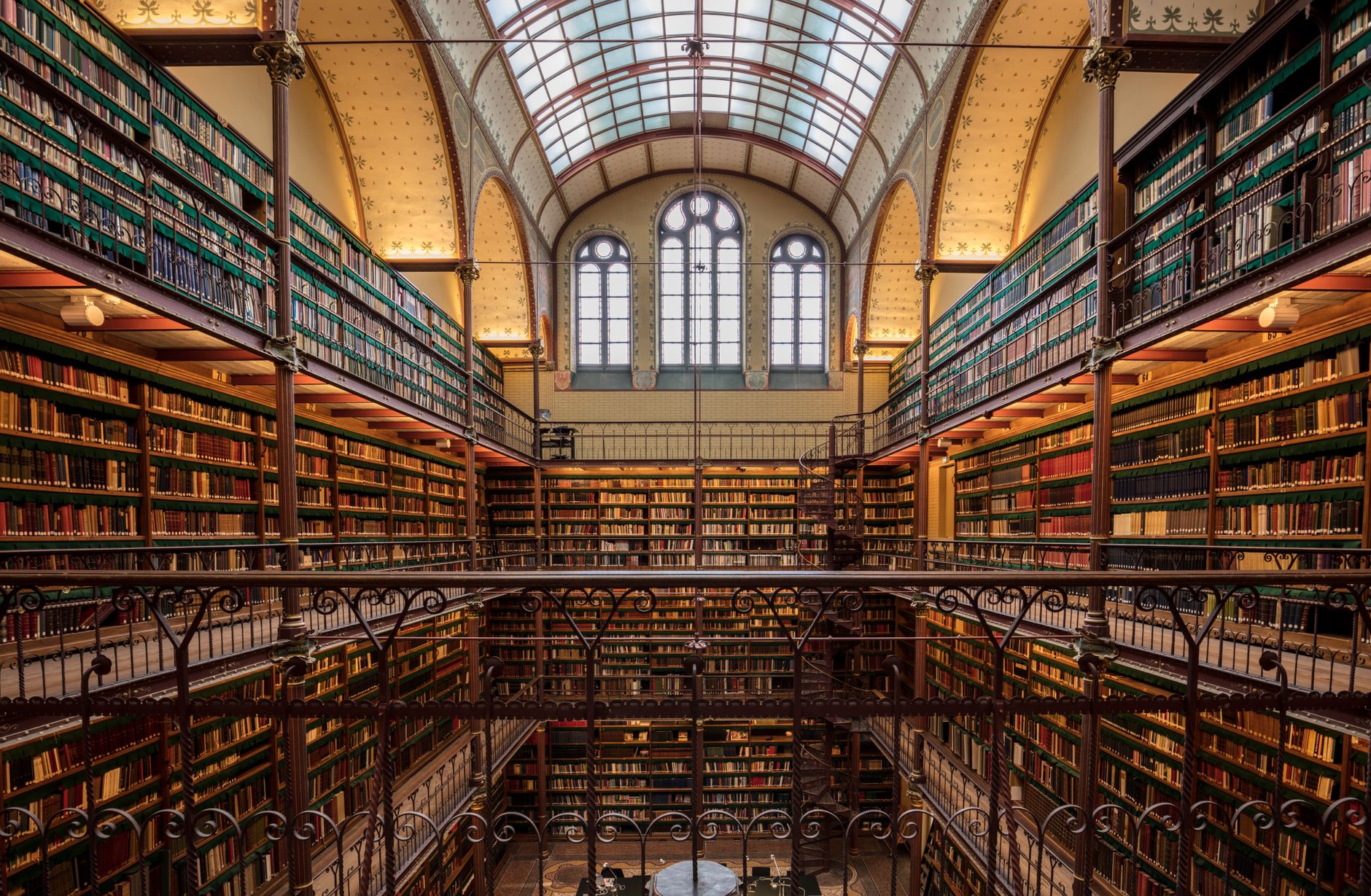 Explore the ornate and historic library interior at Amsterdam's Rijksmuseum, filled with ancient books and architectural beauty.