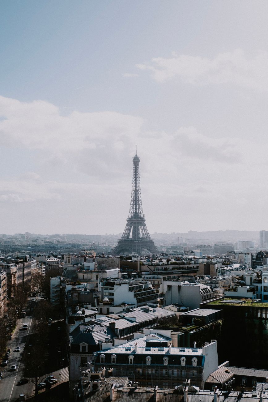 Charming urban street scene in Paris with classic architecture and the Eiffel Tower.