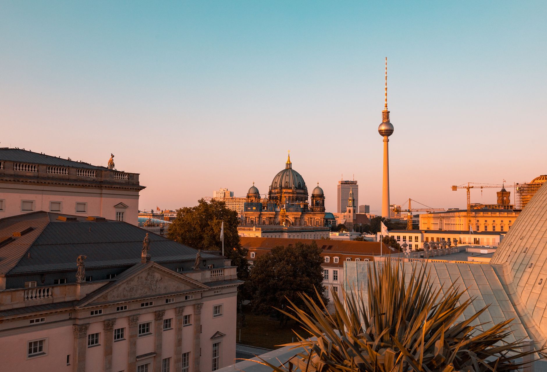 A stunning view of Berlin's historic cityscape featuring the Berlin Cathedral and TV Tower at sunset.